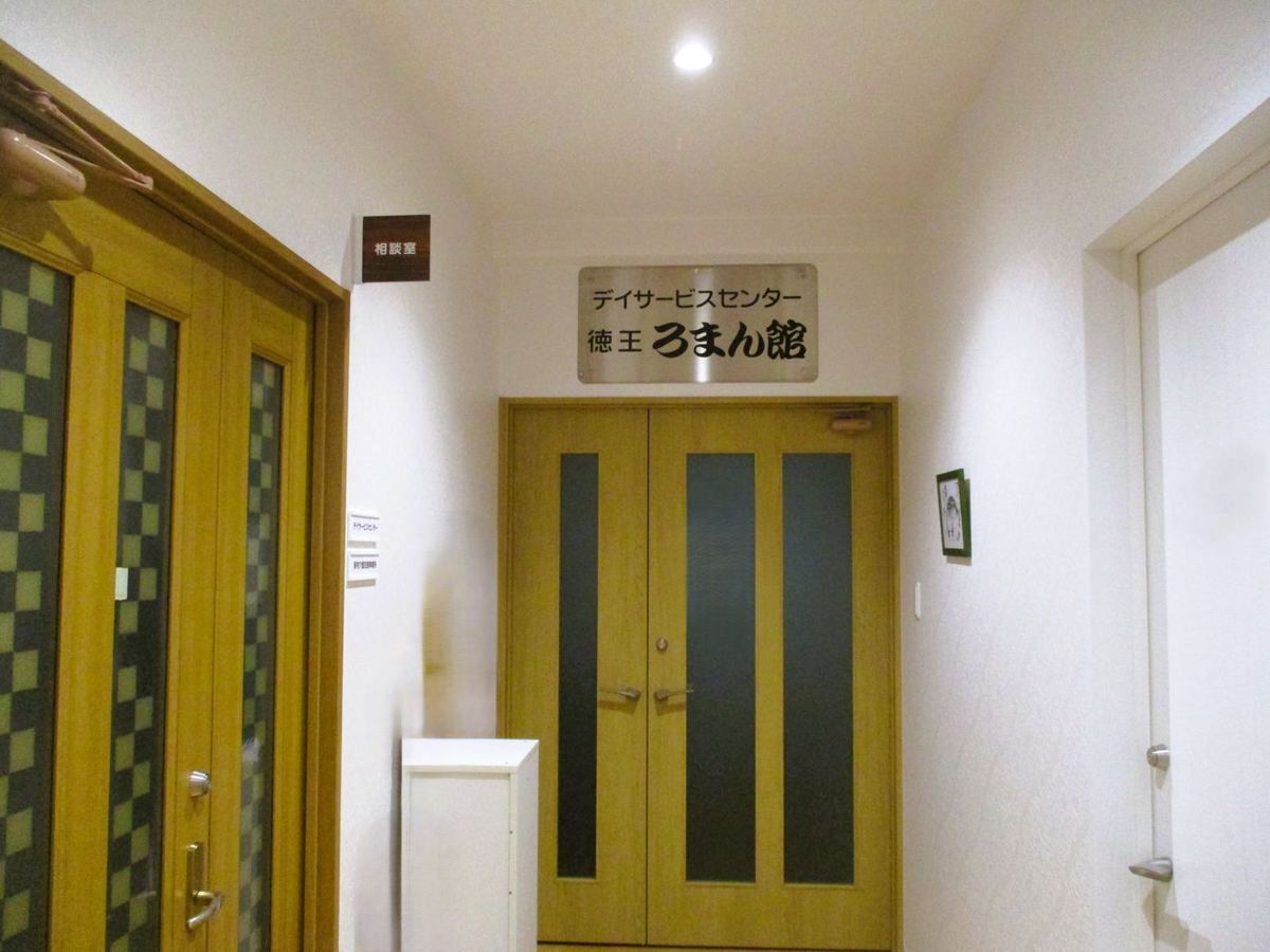 徳王ろまん館の入り口のドアと看板